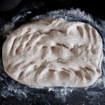 Dough, flattened with fingertips for final time
